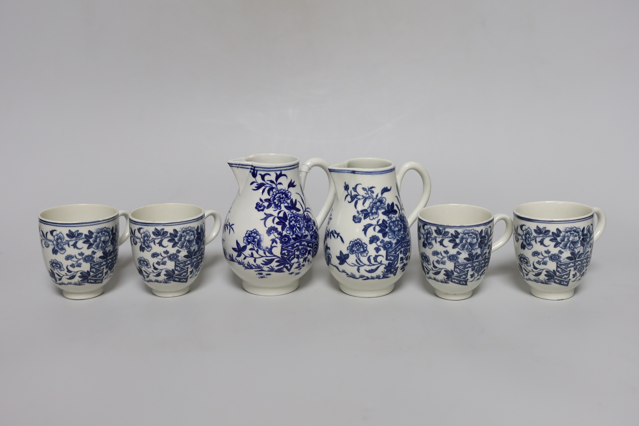 A Worcester sparrowbeak jug printed with the Fence pattern, another sparrowbeak similar and four Worcester coffee cups all printed with the Fence pattern